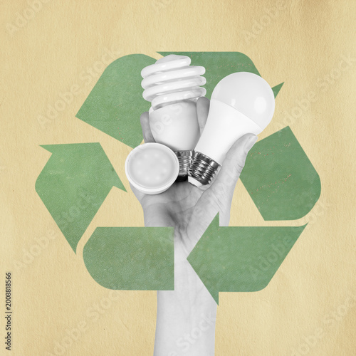 Hand holding led and cfl light bulbs against a recycling symbol, promoting sustainability