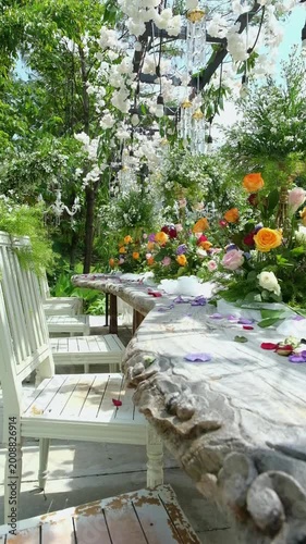 Cinematic shot of floral decoration against blue sky in garden setting. Bright natural lighting enhances color and atmosphere, perfect for wedding, celebration, and outdoor lifestyle visuals.
