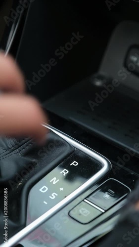 Close up of hand shifting automatic car gear from park to drive. Concept of driving, mobility, transportation, and vehicle control, suitable for automotive and lifestyle visuals.
