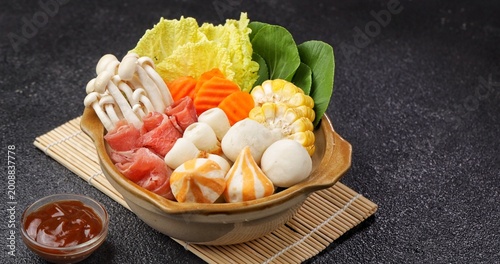 Fotografie Sukiyaki and shabu-shabu, popular Japanese hot pot dishes featuring thinly sliced beef, fresh vegetables, tofu, mushrooms, noodles, and flavorful broth