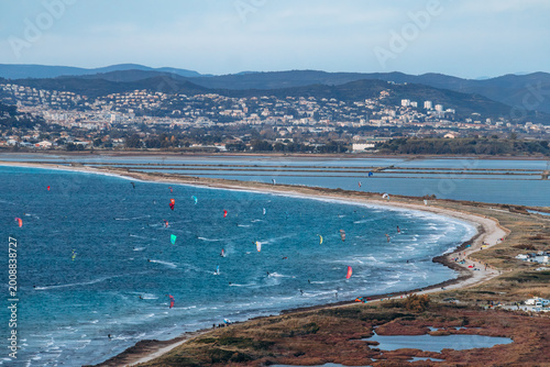 Panoramic view over the Giens peninsula and its double tombolo with sandy coastline, lagoon and kite surfers seen from viewpoint
