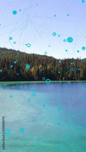 Vertical video: Teal overlay rising, drifting down and growing over lake and trees, showing links