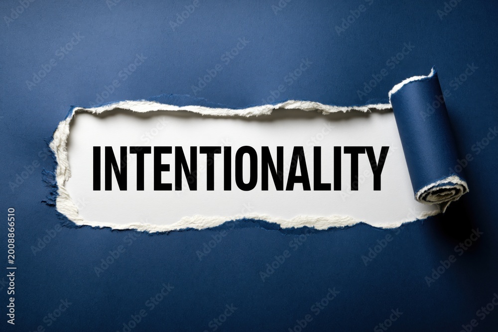 Fototapeta premium Intentionality a single word concept on a torn paper background