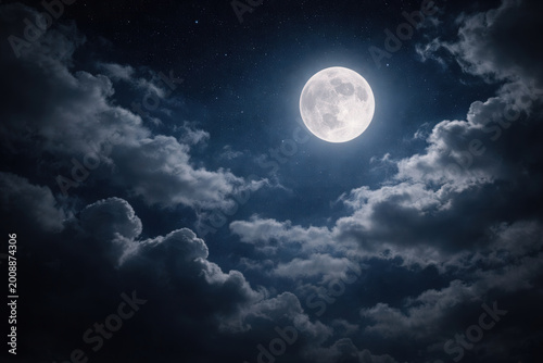 Full Moon Shining Through Clouds In Starry Night Sky