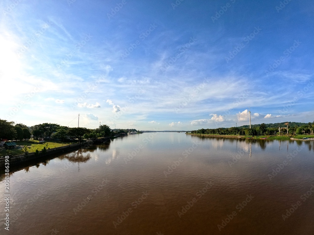 Fototapeta premium Wide angle view of the Mahakam River under a blue sky, East Kalimantan, Indonesia.