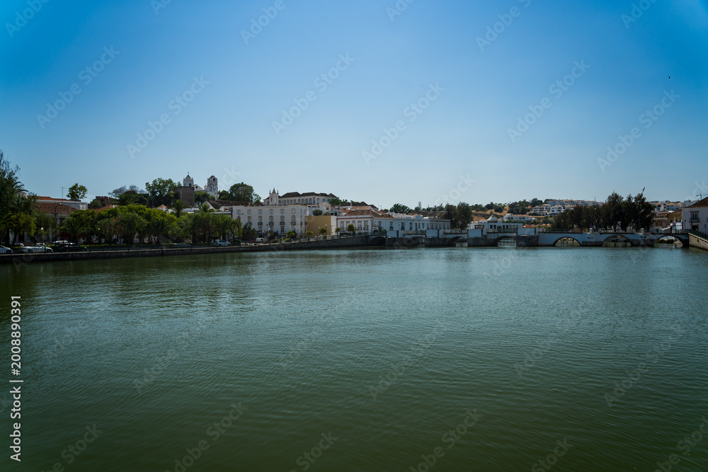 Obraz premium Faro's Historic Waterfront Reflection Under a Bright Blue Sky
