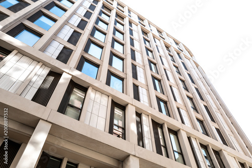 Abstract view of a city of London apartment building showing the modern design. The sky is reflecting off some of the windows.