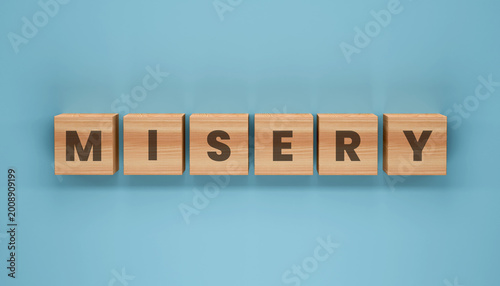 Bild auf Leinwand Misery Word Blocks: A collection of wooden blocks spelling out the word MISERY against a tranquil backdrop, visually expressing emotions of sadness and despair