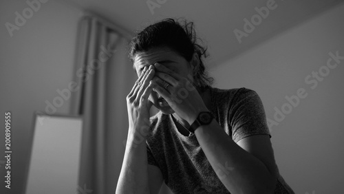 Fotografie Exhausted woman covering face with hands in frustration and emotional distress a