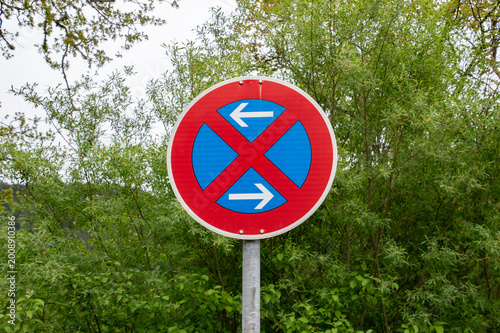 No Stopping Traffic Sign with Double Arrow on Roadside in Green Environment