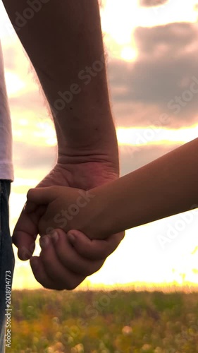 happy family, father holding child hand sunset, toddler child parent holding hand nature, Safe with dad, Father-and-daughter relationship, Father-and-son bond, Childhood security, Loving embrace