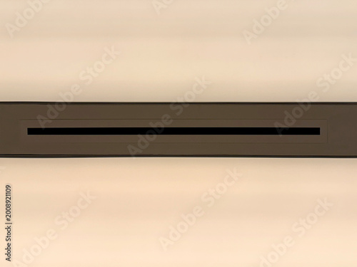 Close up metal cladding with horizontal stripes pattern in bronze and white color paint. Illuminated from behind. Suitable for ceiling, wall, materials, texture, architecture. Seamless background text