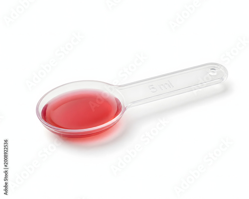 Medicine Measure: A transparent measuring spoon, precisely calibrated with a bright red liquid medication, epitomizes precision and care within healthcare.