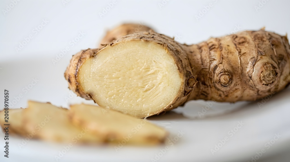 Fototapeta premium Fresh raw ginger root pieces on white background