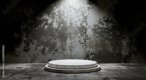 A large spotlight shines on a white circular podium in a dark room with a grungy wall and floor