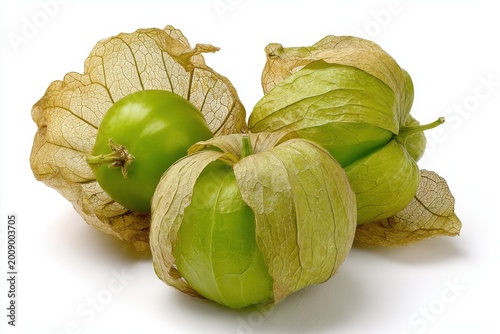 Minimalist still life: trio of tomatillos on a plain white surface