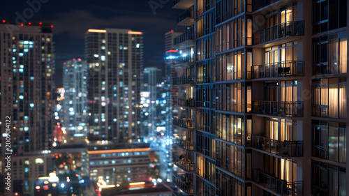 high-rise condo at night with illuminated windows, city lights glowing, cinematic urban luxury scene