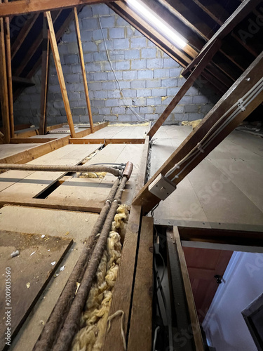 UK loft interior with pitched roof timbers and boarded floor