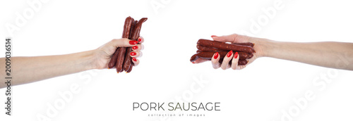 Foto Pork sausage in hands isolated on white background.