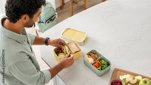 Man preparing healthy lunch with vegetables and fruits at home  
