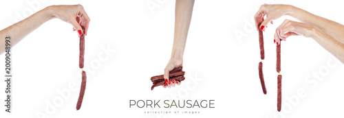 Foto Pork sausage in hands isolated on white background.