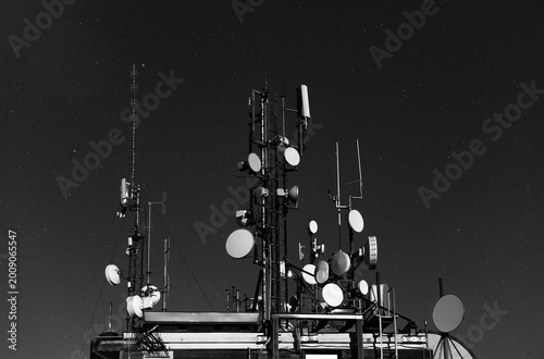 Dense Telecommunications Structure with Multiple Antennas, Masts, and Satellite Dishes