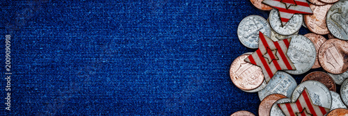 Foto Coins are placed on denim fabric with a striped paper, showing different amounts
