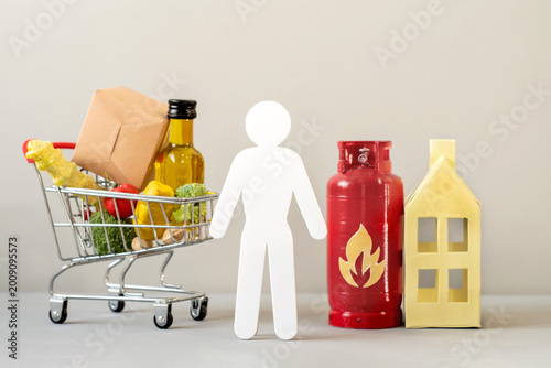 A person choosing between food and household energy costs. Rising cost of living and family budget decisions. Savings strategy. Purchasing power
