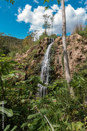 Natural Waterfall Flowing Down a Rocky Cliff