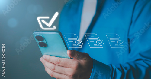 checkmark for digital approval and task completion. online procurement documents, contract warranties and licenses on mobile procurement devices for businesses and startups