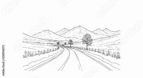 Winding road through snowy fields towards distant, majestic mountains