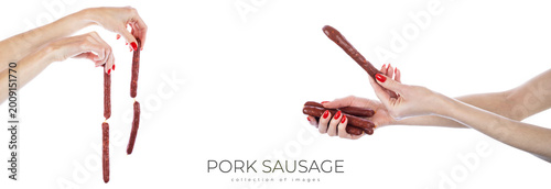 Bild auf Leinwand Pork sausage in hands isolated on white background.