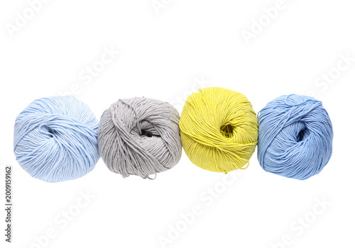 Tableau sur toile Set of four yarn balls for knitting, blue gray yellow wool skeins isolated on tr