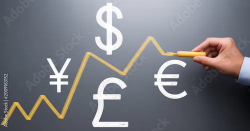 Hand drawing growth chart with different currency symbols dollar euro yen pound concept.