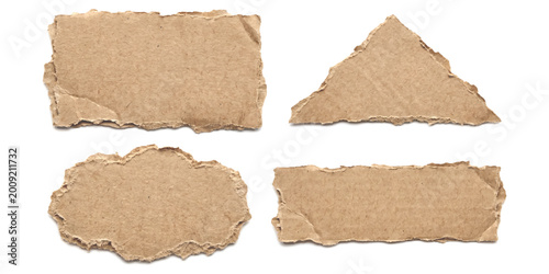 Foto Set of four torn pieces of brown cardboard paper with rough edges