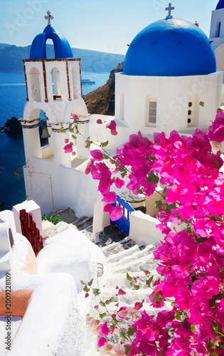 steep stairs and classical church with blue domes at sunny days , Oia, Santorini, Greecer, retro toned