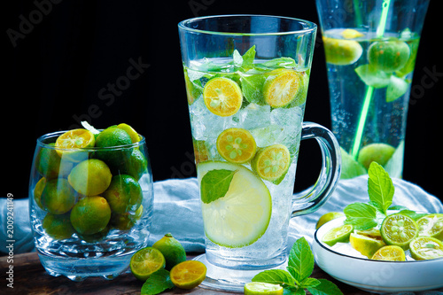 Tableau sur toile Iced calamansi lime drink with mint in clear glasses on dark background
