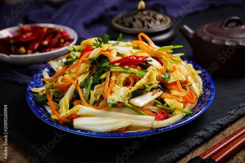 Fotografi Asian stir fried napa cabbage and vegetables on plate