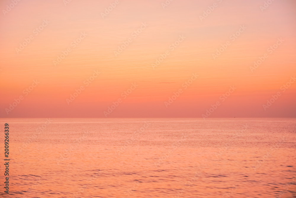 Fototapeta premium Tranquil Orange Sunset Over Calm Sea