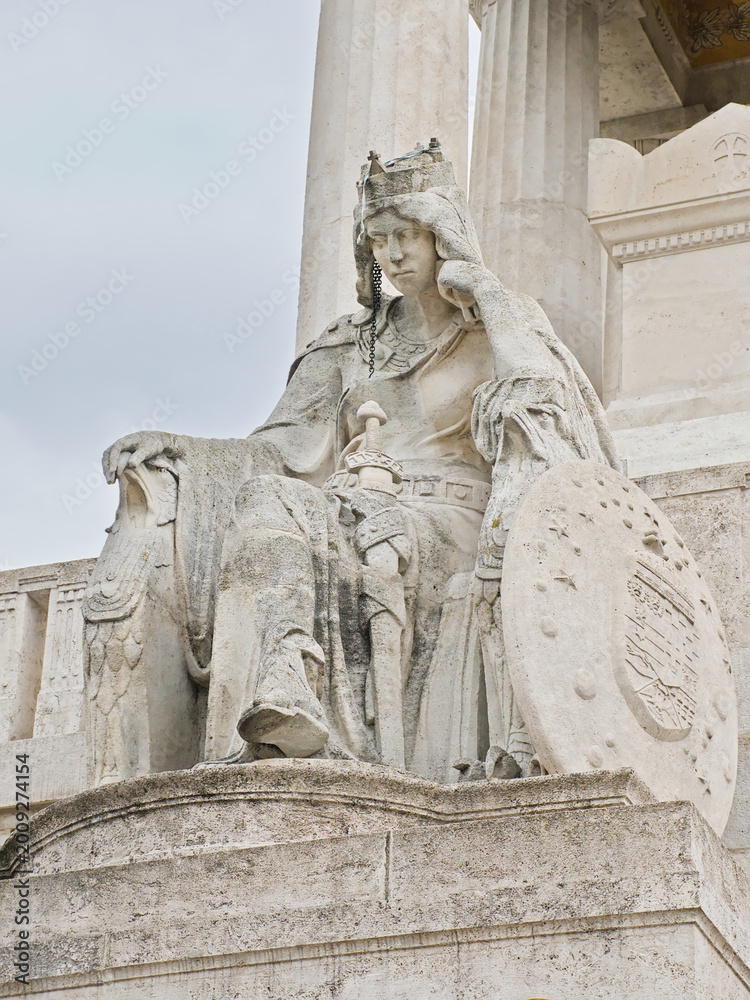 Fototapeta premium Statue of a person with shield and sword, sitting in Kerepesi, historical graveyard along Fiume Road in Budapest, 