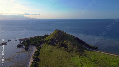 Pulau kenawa island hiking hill with clear ocean. Perfect aerial view drone