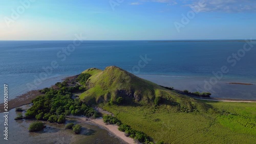 Pulau kenawa island hiking hill with clear ocean. Amazing aerial view drone