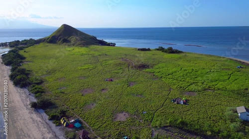 Pulau kenawa island hiking hill with clear ocean. Great aerial view drone