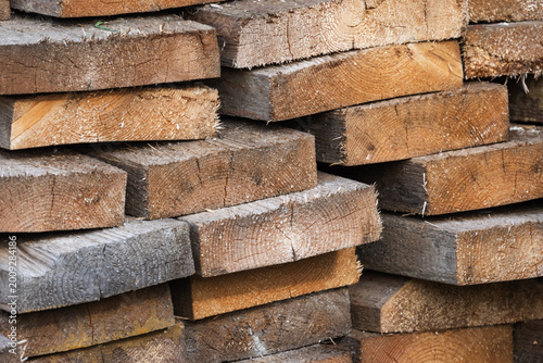 Εκτύπωση καμβά Stacked rough-cut lumber and sawn timber planks showing wood grain, texture and saw marks
