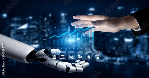 Photos A captivating image showcasing the interaction between a human hand and a robotic arm, emphasizing digital technology with a rising graph and data presentation in a modern city backdrop