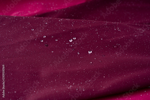 Waterproof fabric texture with rain drops closeup
