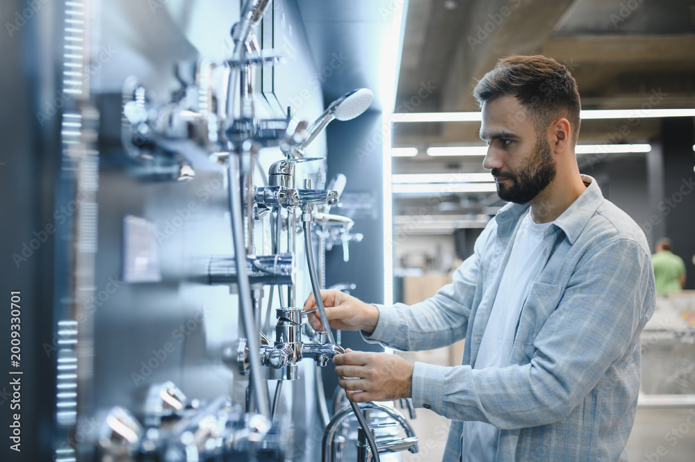 Obraz premium Man choosing shower system in plumbing store