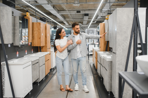 Couple choosing bathroom furniture in home improvement store