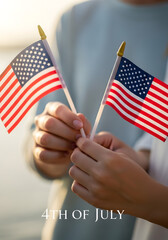 Hands holding small american flags, celebrating 4th of july, patriotic