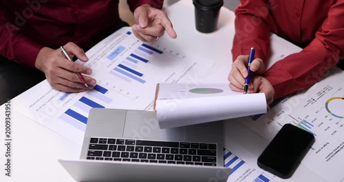 Team of business analysis documents in action office setting report generation professional environment strategic planning